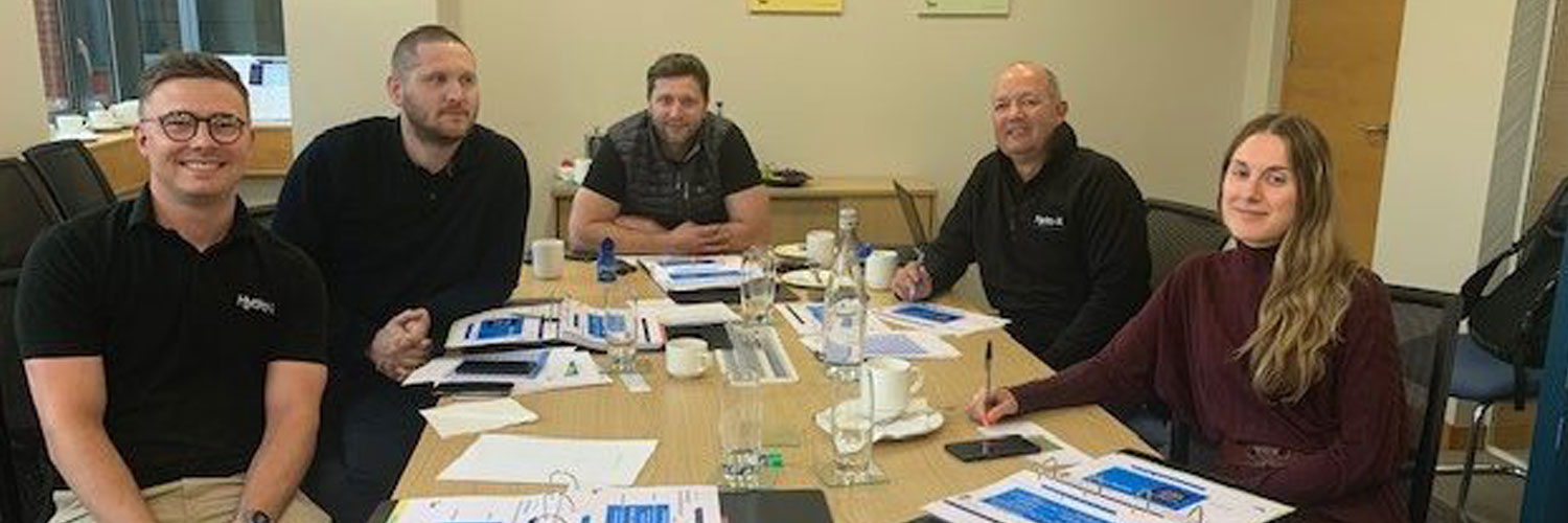 Hydro X team sitting around a table