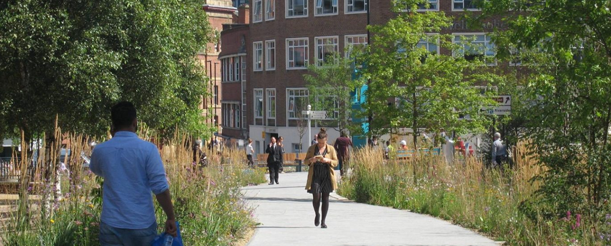 People walking through a green space in Sheffield